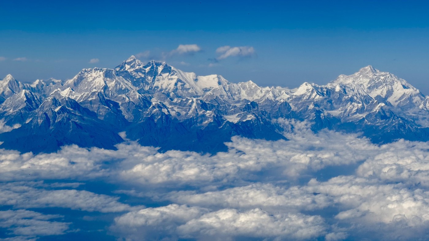 Wide Himalayan mountain range above clouds