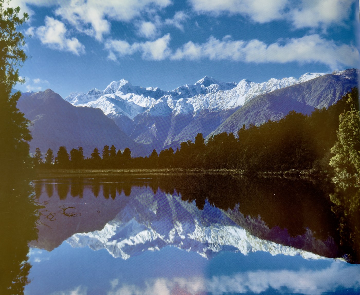 Snow mountains reflected in a still lake